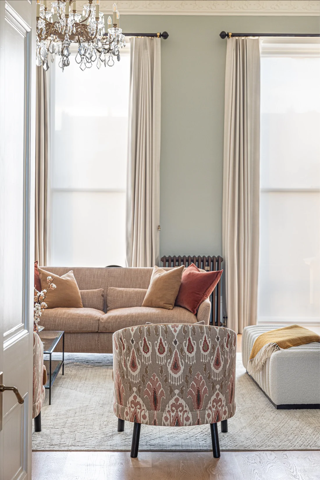 Colourful living room interior design with bespoke made armchairs with decorative backing